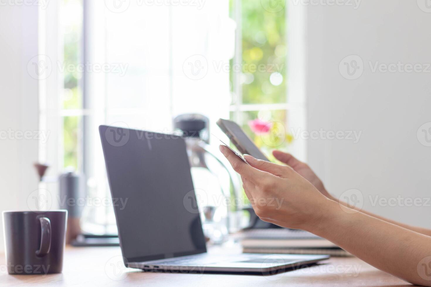 Young woman is shopping online through mobile application by paying with her credit card Convenience of paying through shopping online. Concept of online shopping and spending through credit card. photo