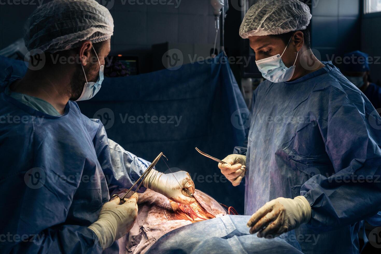 Doctors stitching a patient's back after surgery photo