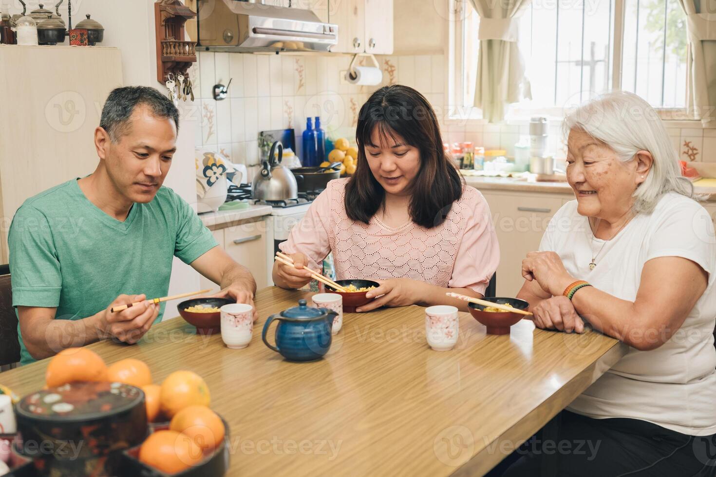 Japanese adult family eating rice with chopsticks. photo
