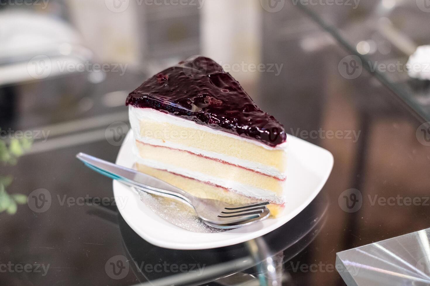 Blueberry Cheese Cake with cream on table photo