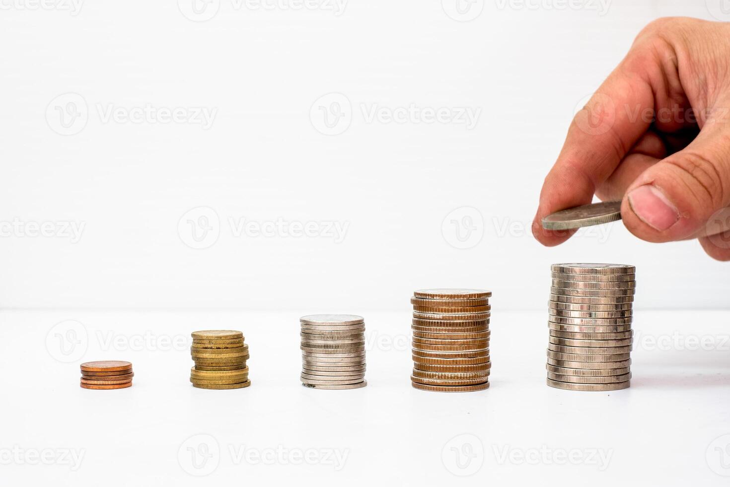 Hand picked coin put on the pile coins funds with value rise photo