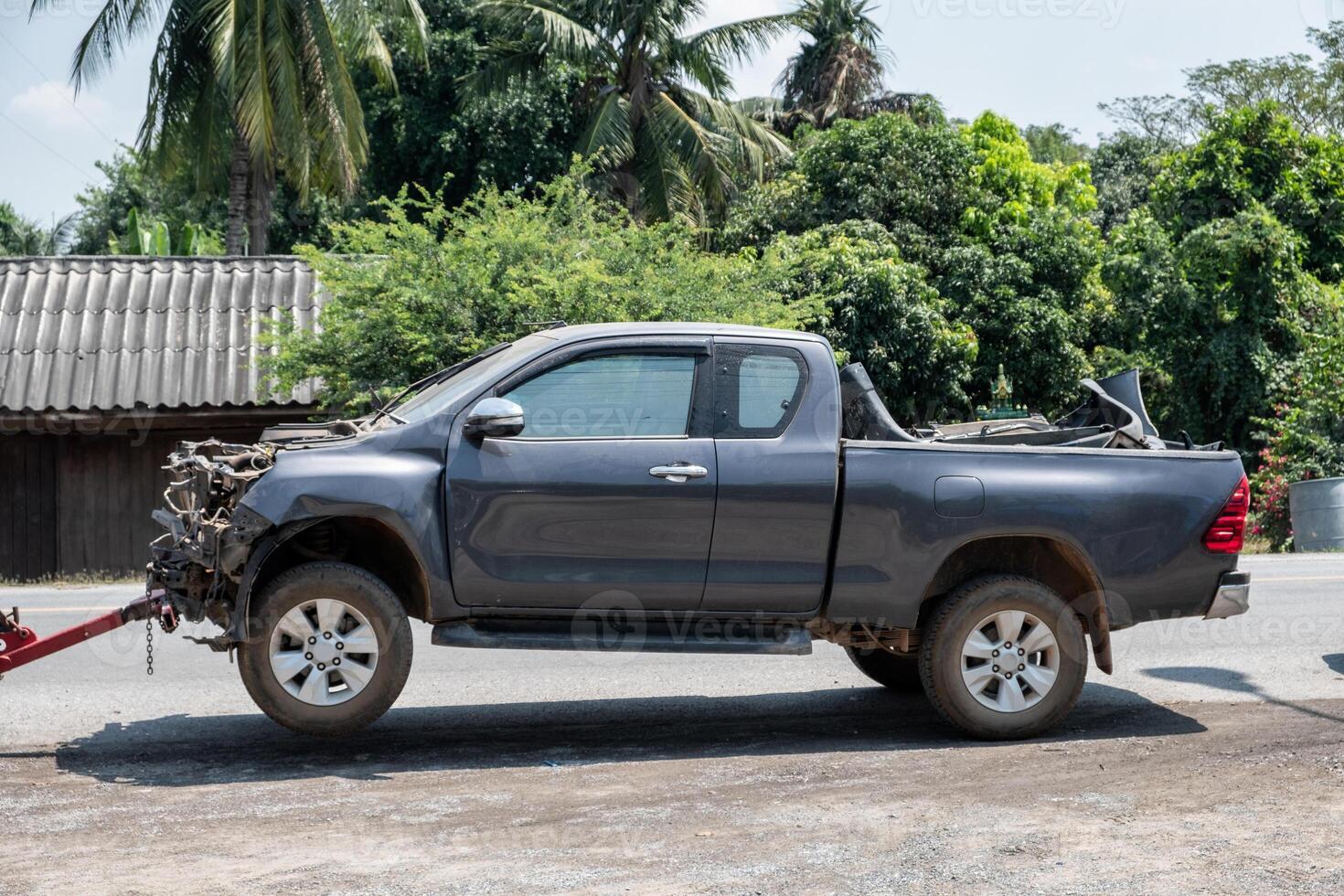 Crashed accident pickup car with towing on road photo