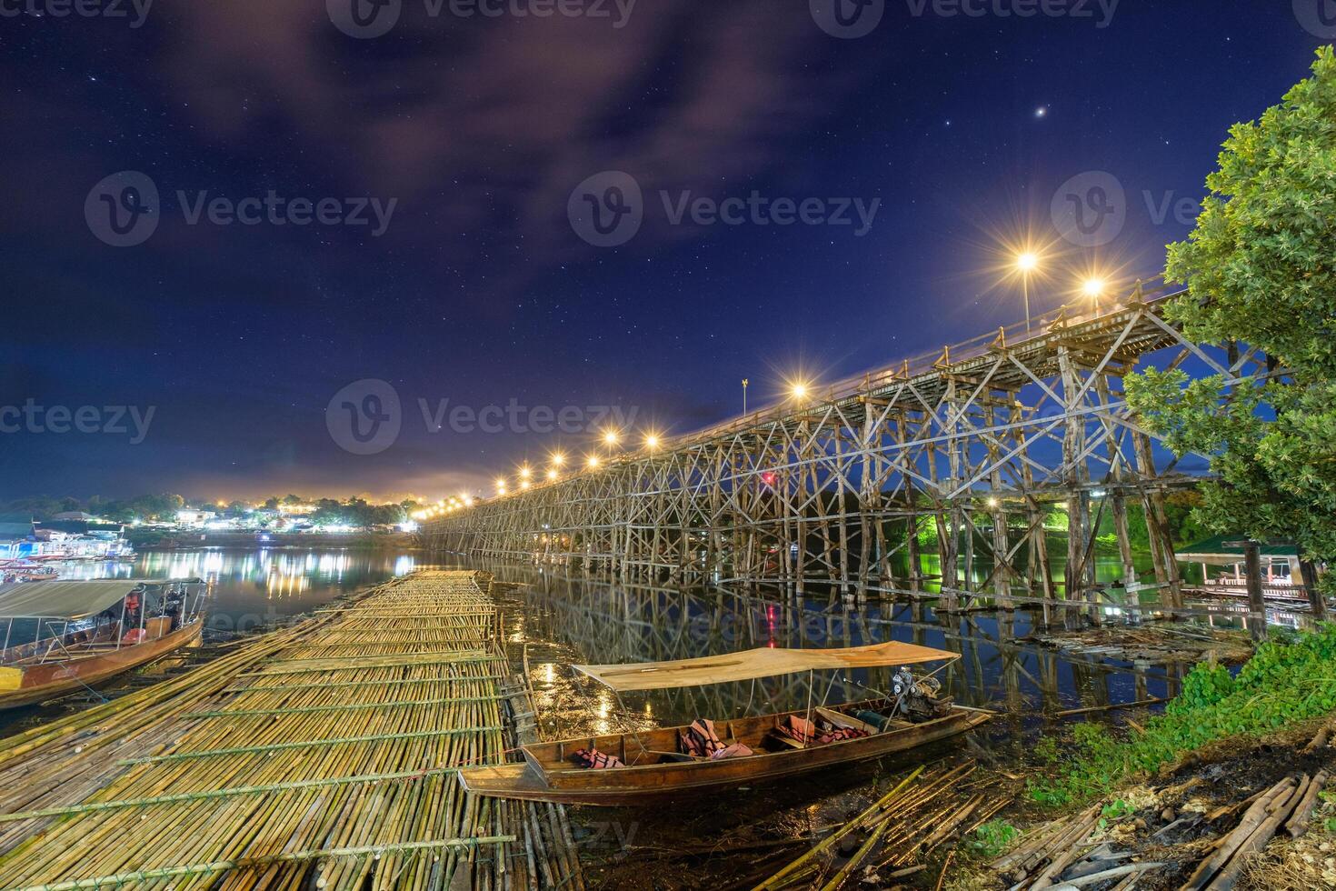 Famous wooden mon bridge in sangkhlaburi at twilight photo