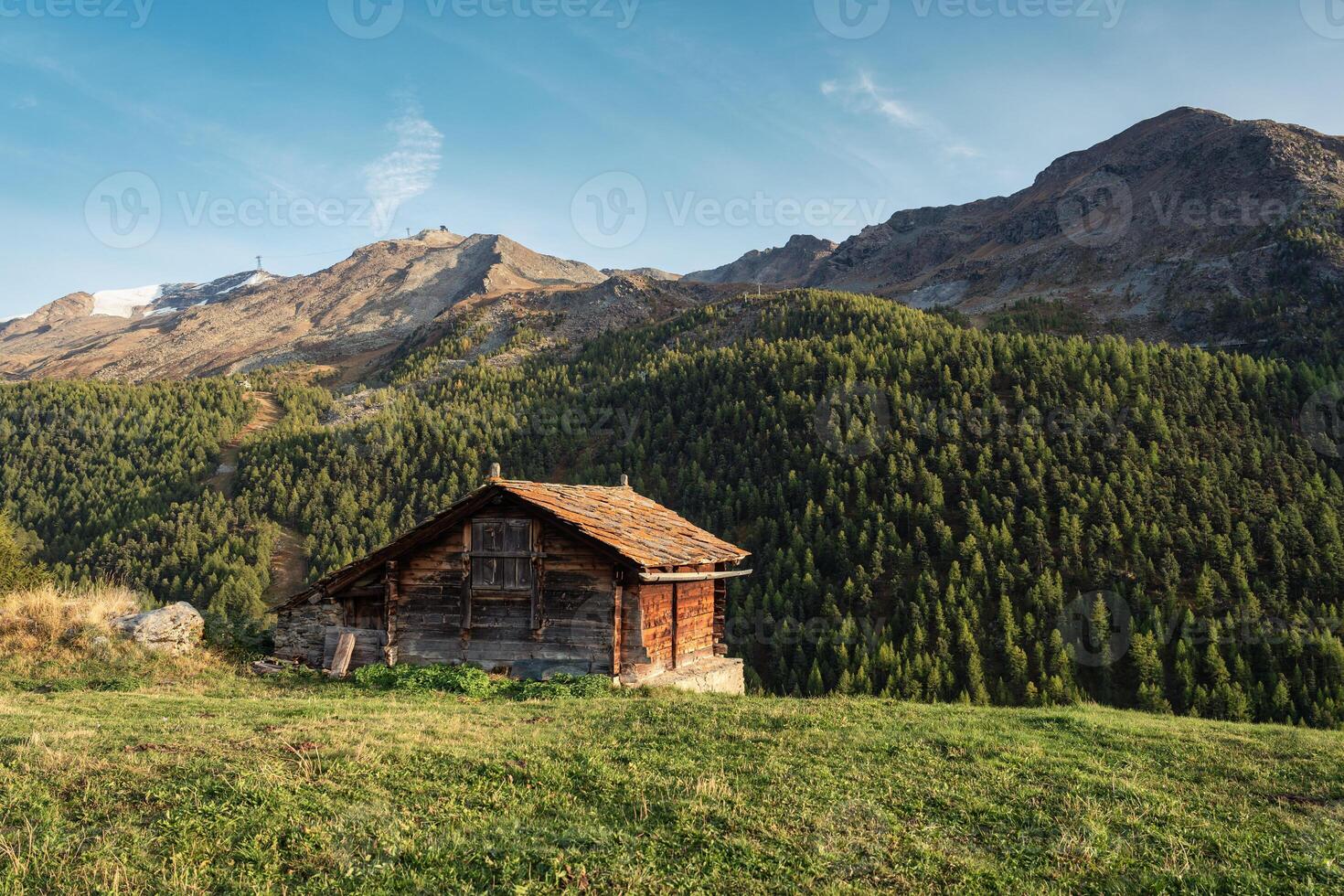 Wooden cottage on hill among the Swiss Alps in mountain village at Zermatt photo