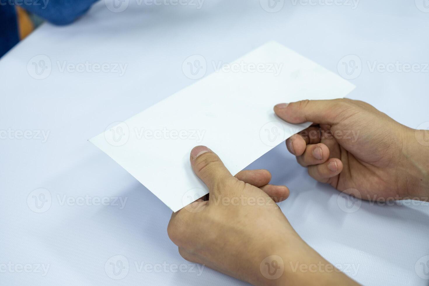 Hand businessman giving blank white envelope photo