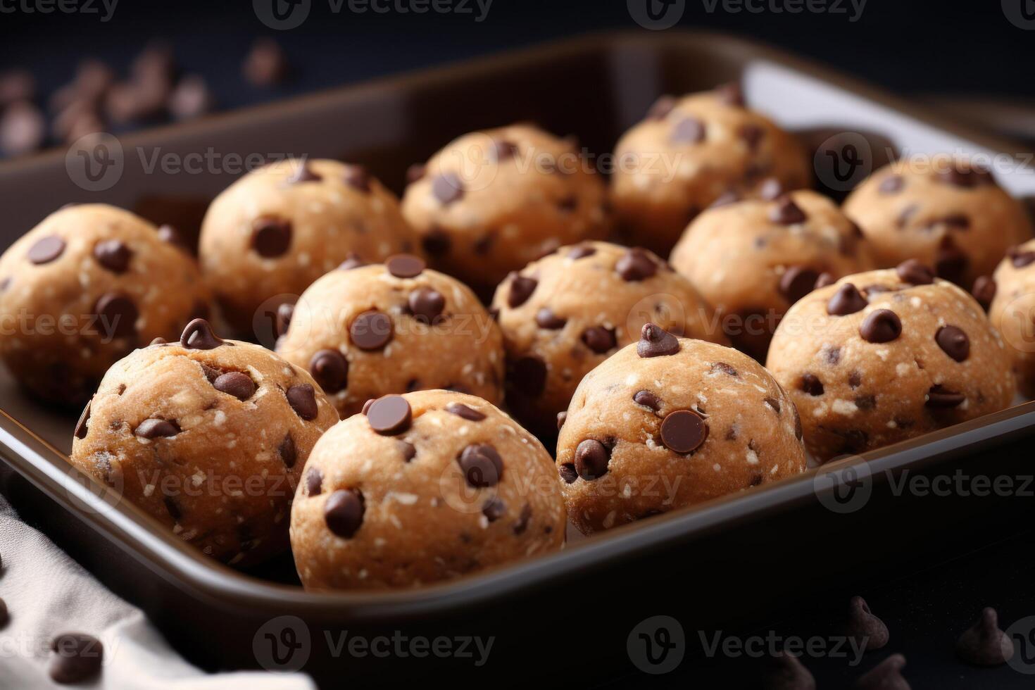 AI generated Baking pan with raw chocolate chip cookie balls on table, closeup photo