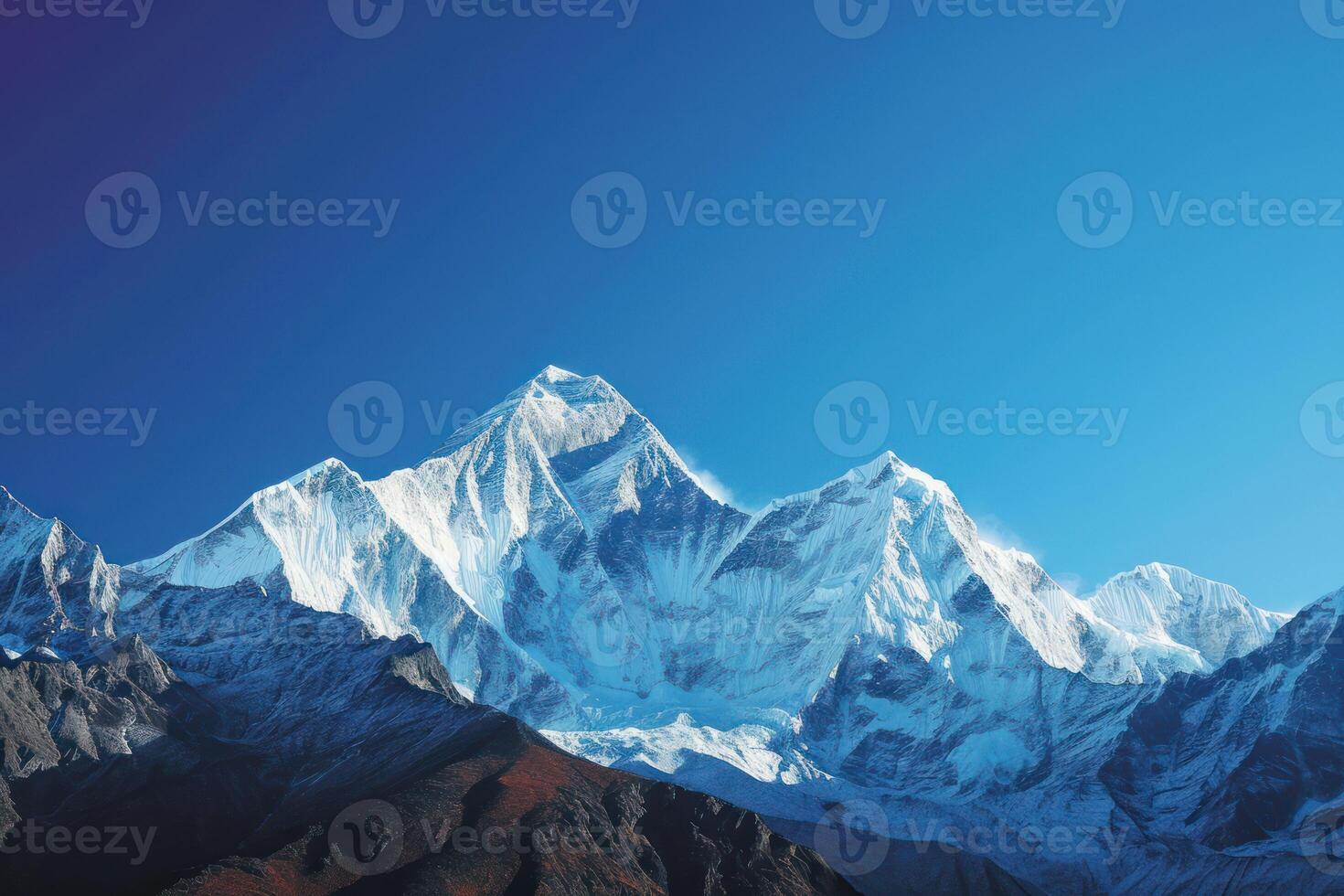 ai generado capturar el grandeza de nevadas picos en contra un claro azul cielo foto