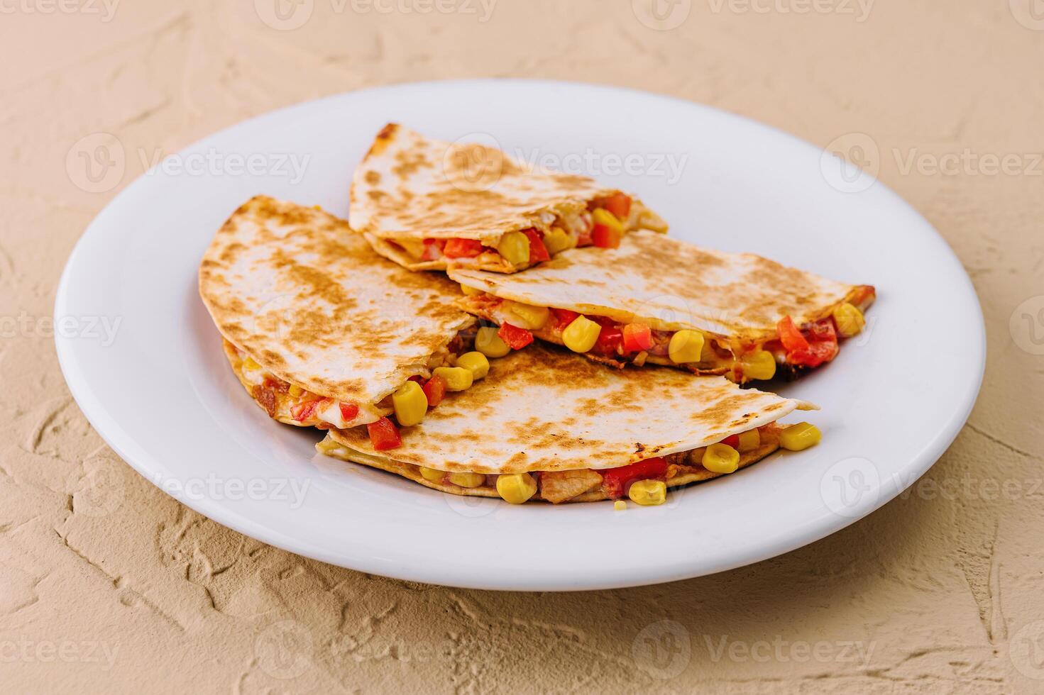 Mexican quesadilla with vegetables on plate photo