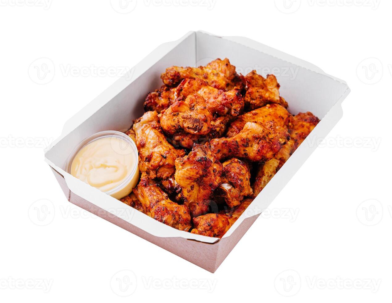 Fried chicken wings and legs in a paper box photo