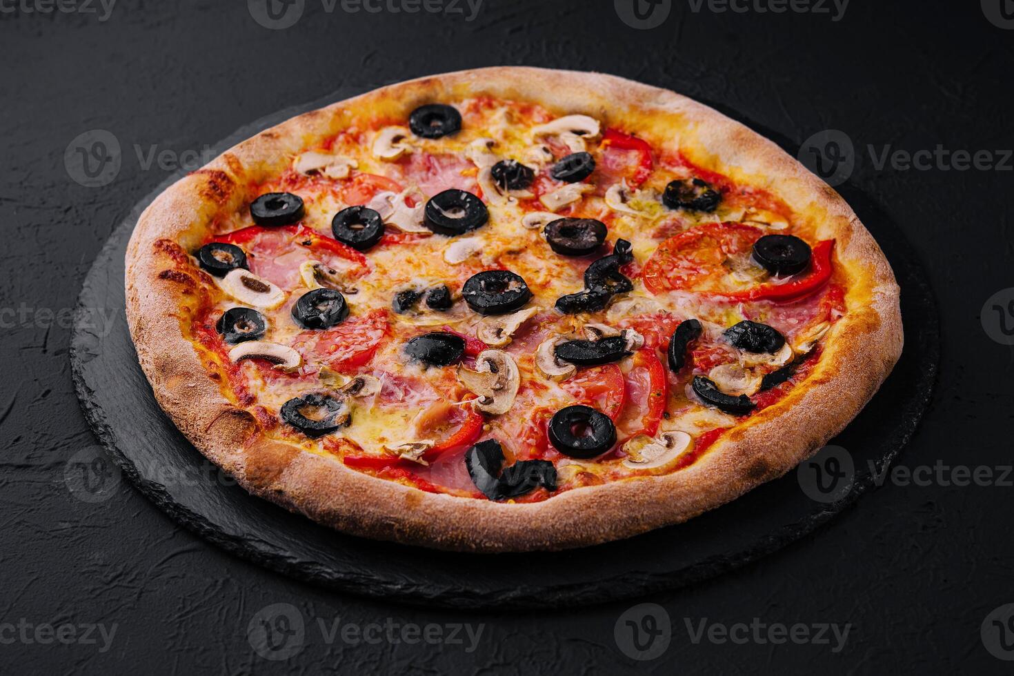 Pizza with tomato, olives, champignons, ham and cheese photo