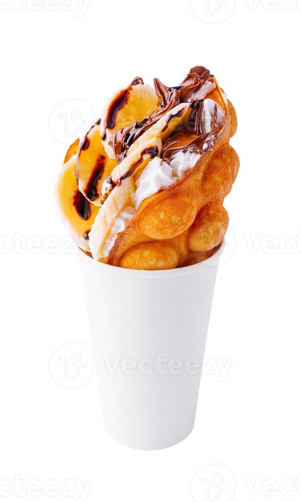 hong kong or bubble waffle with whipped cream, chocolate and bananas photo