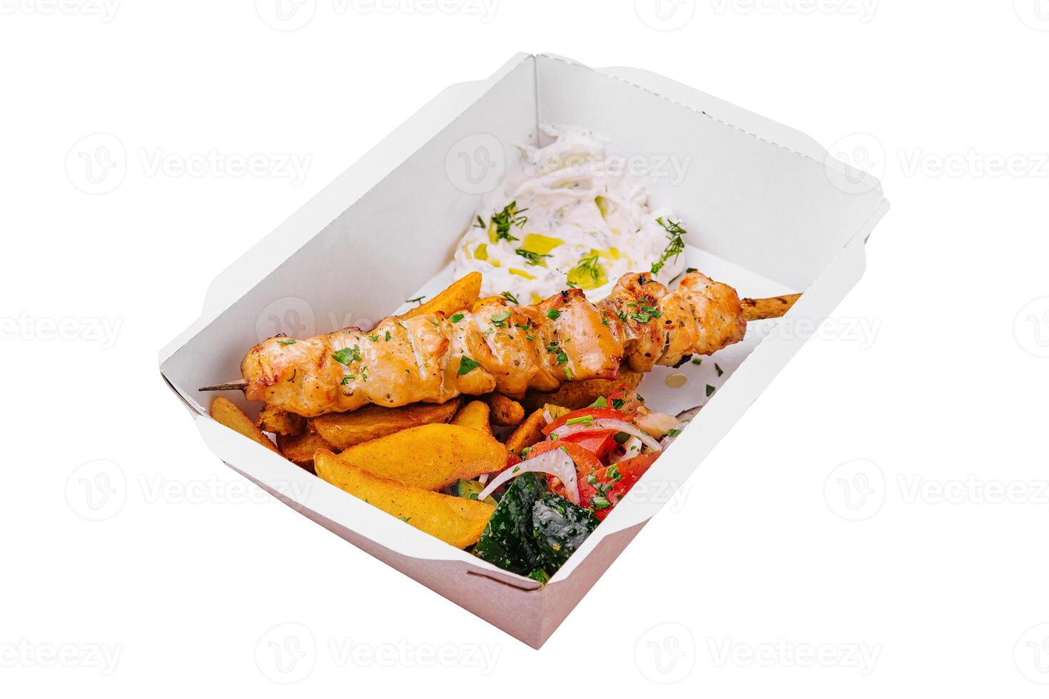 Chicken skewers with potatoes and tomato and onion salad photo