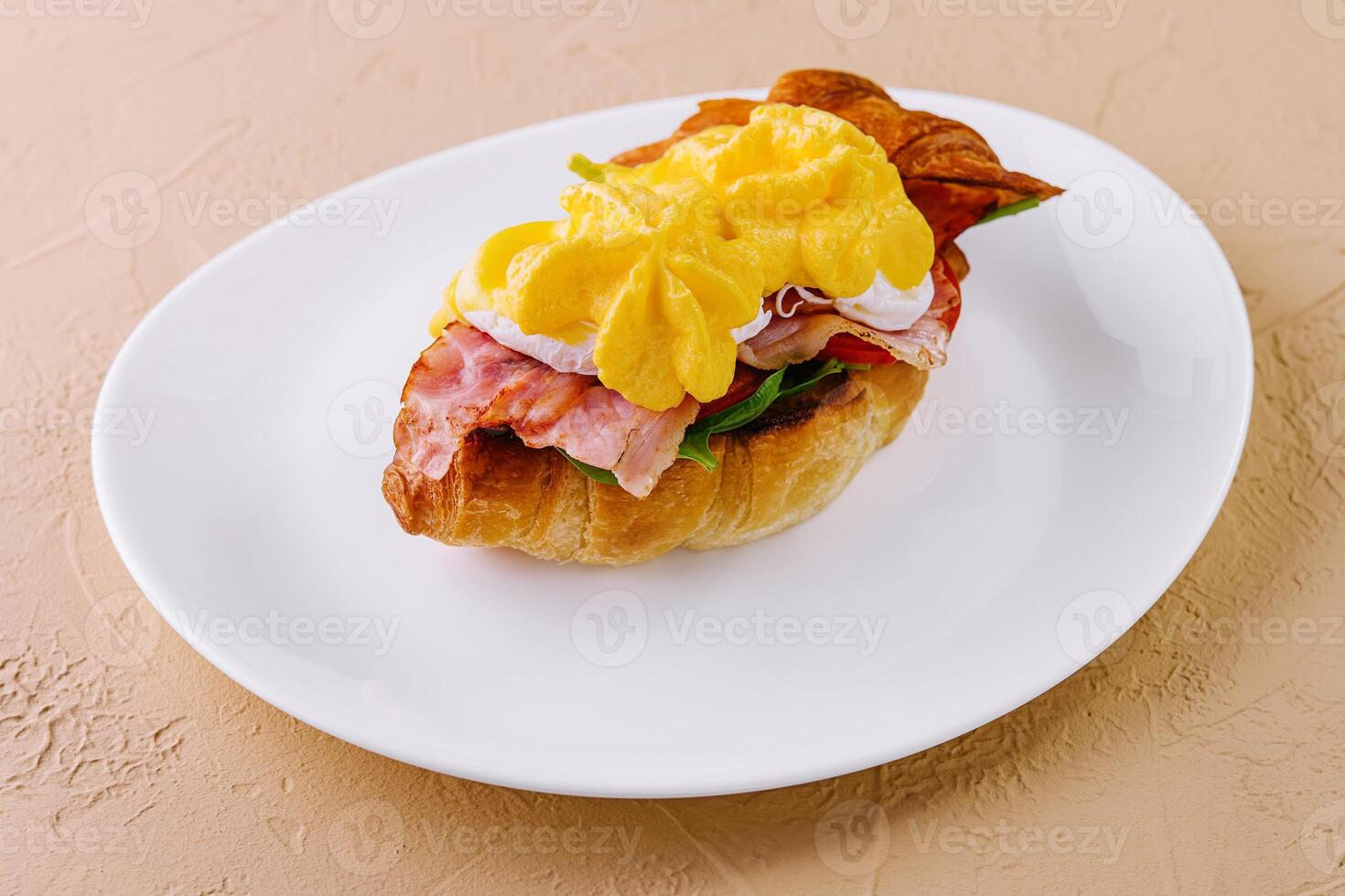 Croissant sandwich with bacon, cheese and egg photo