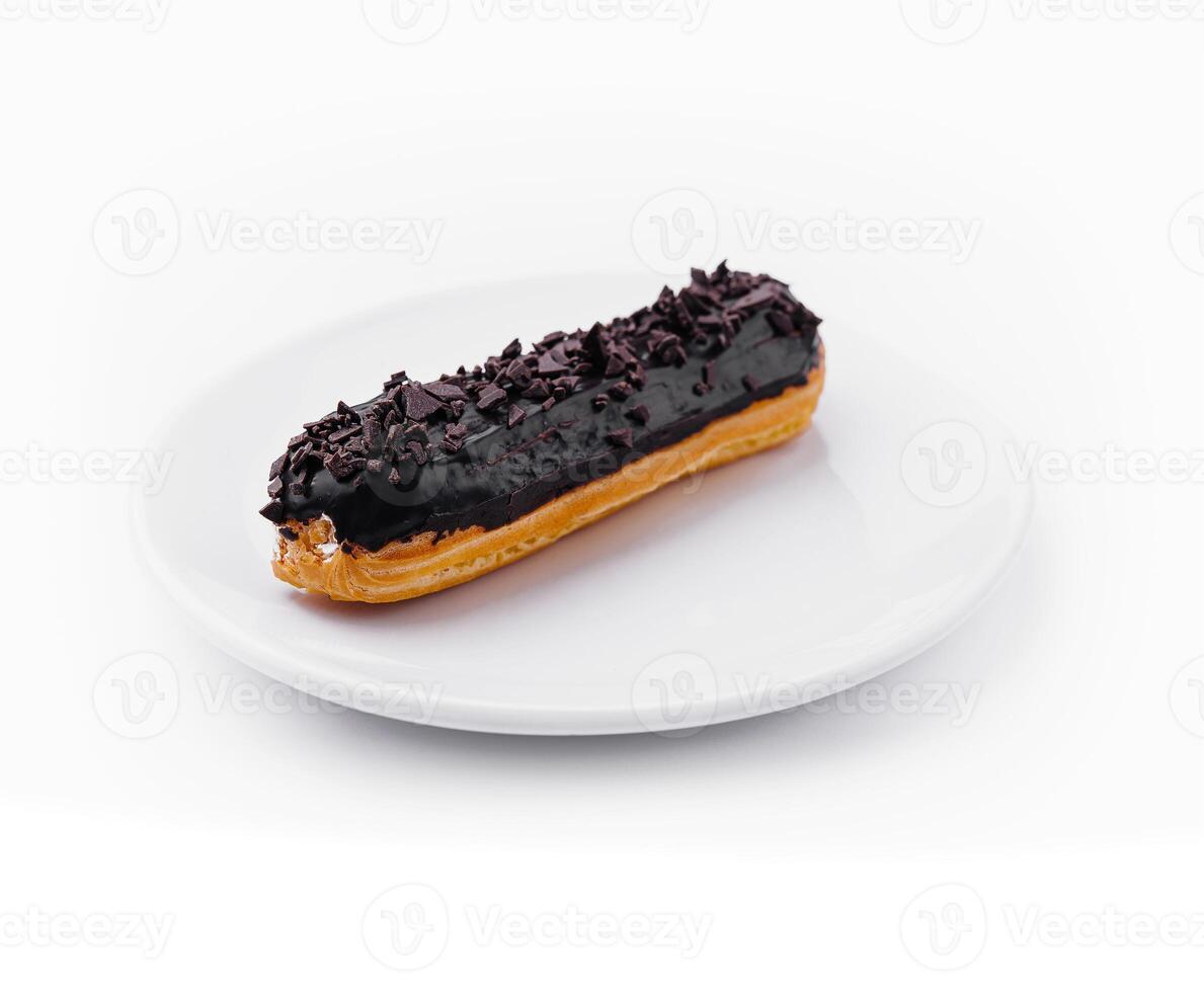 delicious chocolate French eclair on plate photo