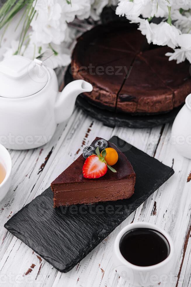 Dark chocolate cake and cup of coffee photo