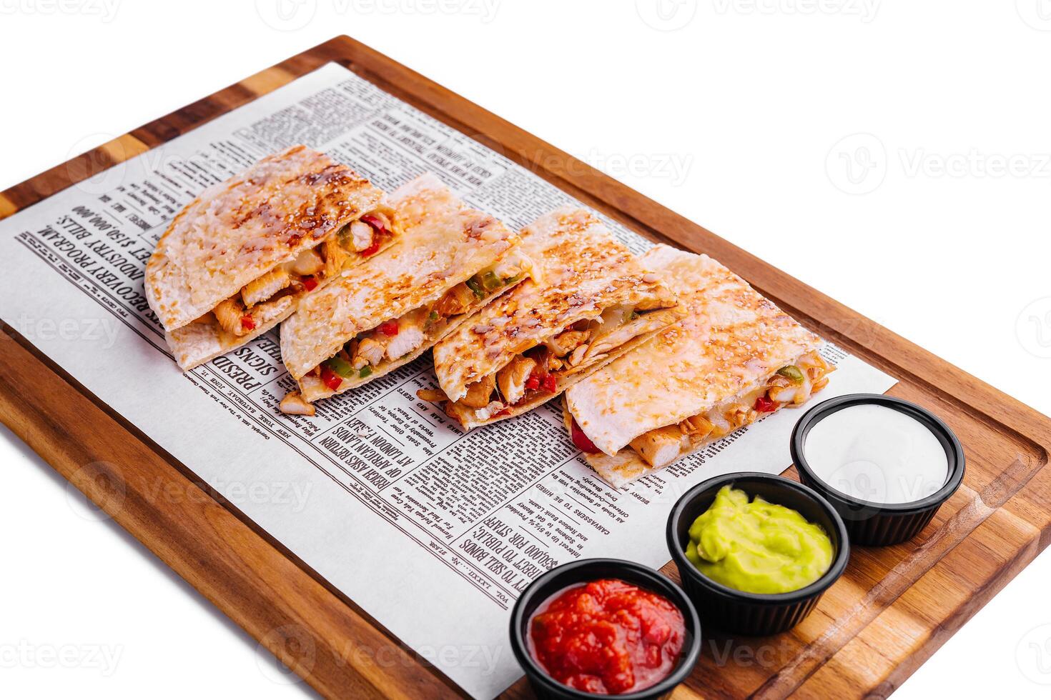 Mexican quesadilla with chicken on wooden board photo