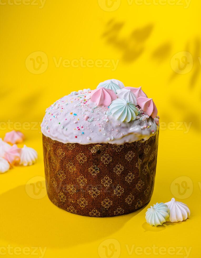 Traditional Easter cakes with meringue on yellow background photo