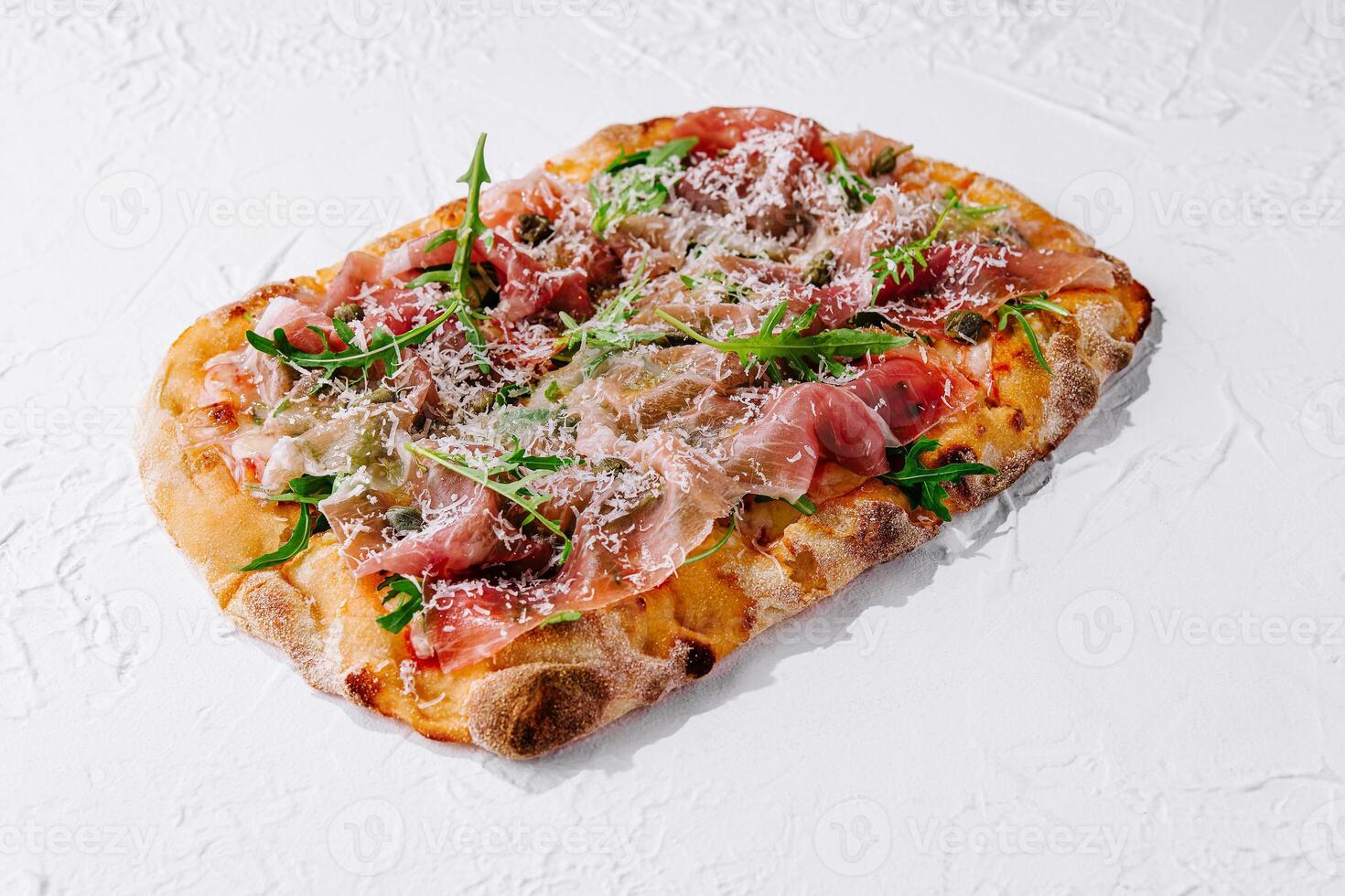 square pizza with prosciutto and arugula photo