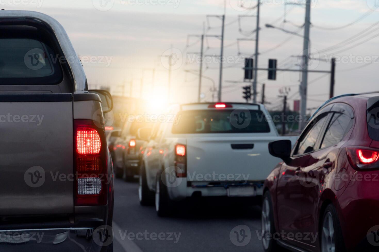 Rear side of pickup car with turn on brake light on asphalt roads. During rush hours for travel or business work. Environment of traffic jam with many cars. photo