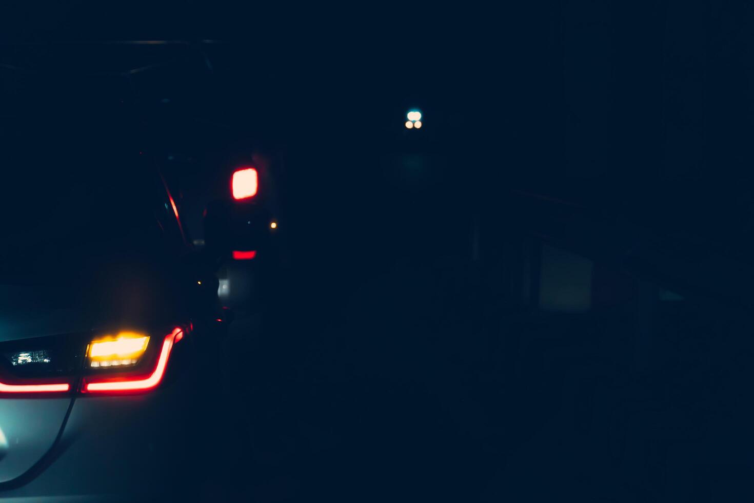 Abstract and blurred image of cars on the road with light break during the night. Overall atmosphere was dark and only lights could be seen. photo