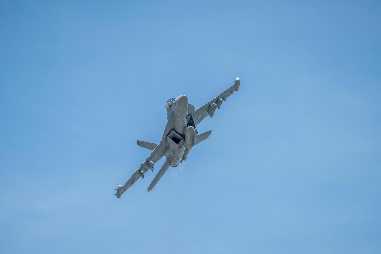 a fighter jet flying in the blue sky photo