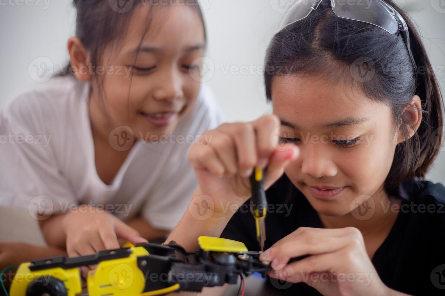 nventive kids learn at home by coding robot cars and electronic board cables in STEM. constructing robot cars at home photo