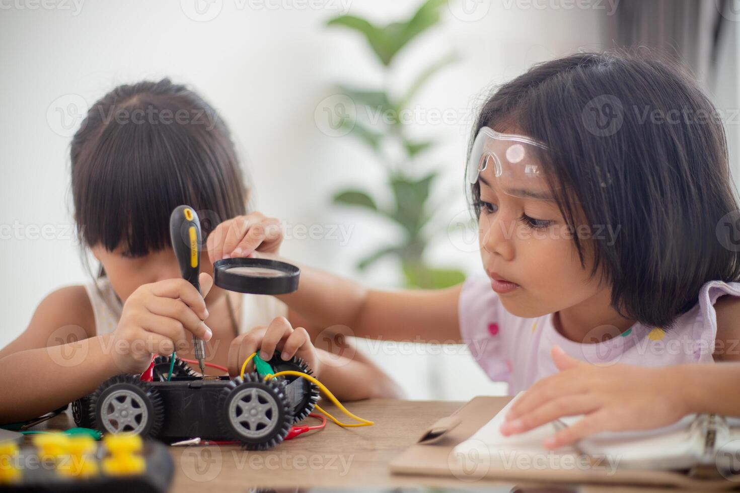 nventive kids learn at home by coding robot cars and electronic board cables in STEM. constructing robot cars at home photo