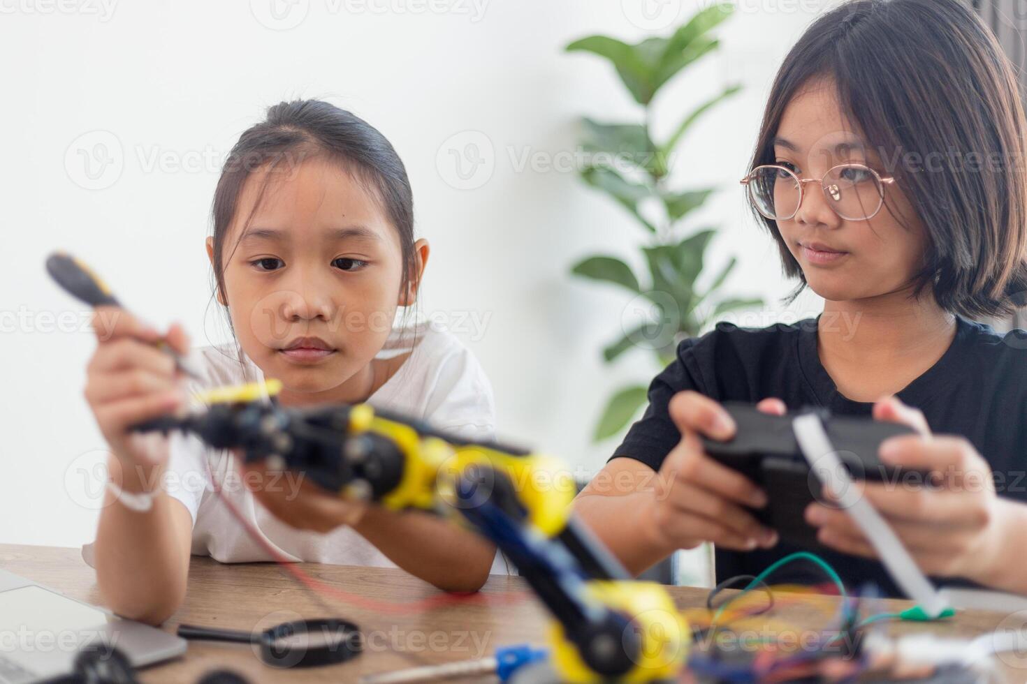 nventive kids learn at home by coding robot cars and electronic board cables in STEM. constructing robot cars at home photo