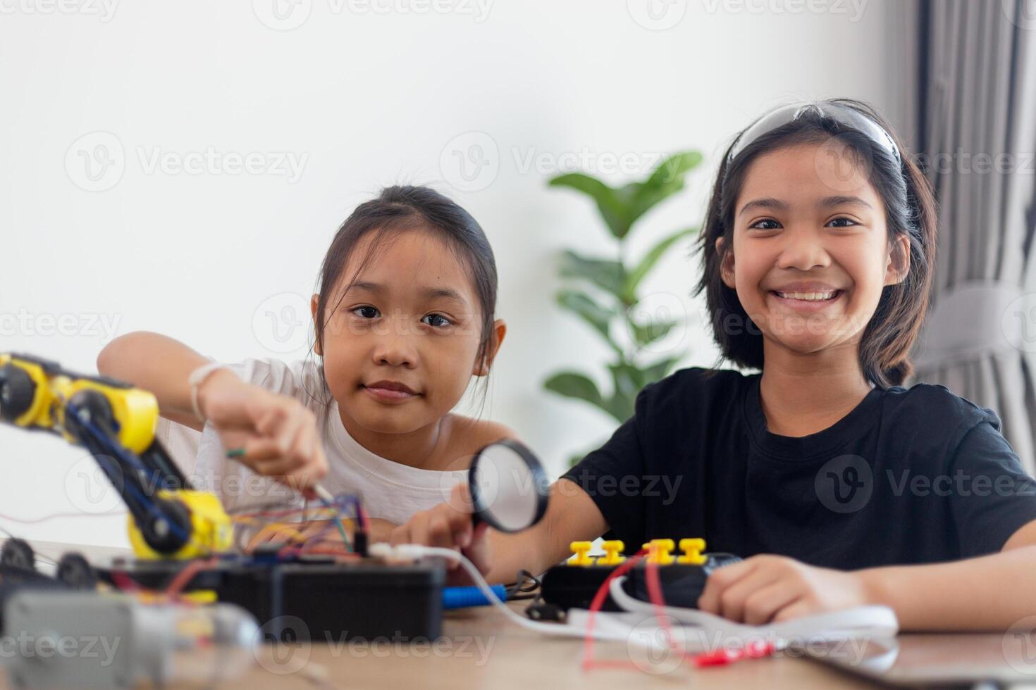 nventive kids learn at home by coding robot cars and electronic board cables in STEM. constructing robot cars at home photo