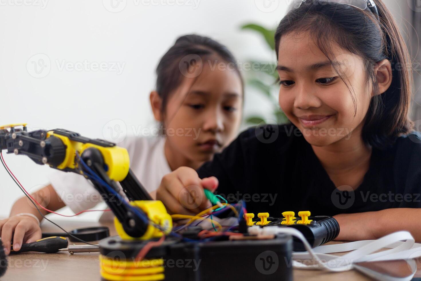 nventive kids learn at home by coding robot cars and electronic board cables in STEM. constructing robot cars at home photo
