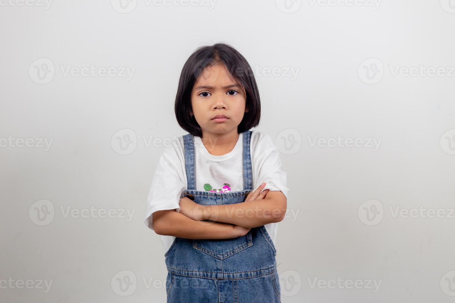 Angry little girl over white background, sign and gesture concept photo