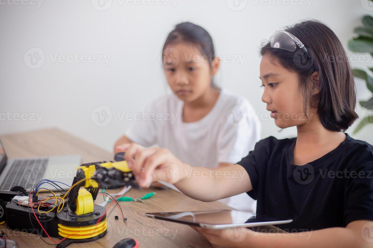 nventive kids learn at home by coding robot cars and electronic board cables in STEM. constructing robot cars at home photo