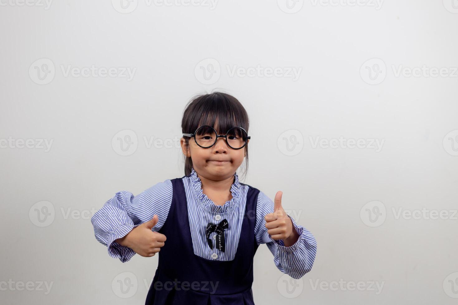 funny Asian child girl wearing glasses on a white background photo