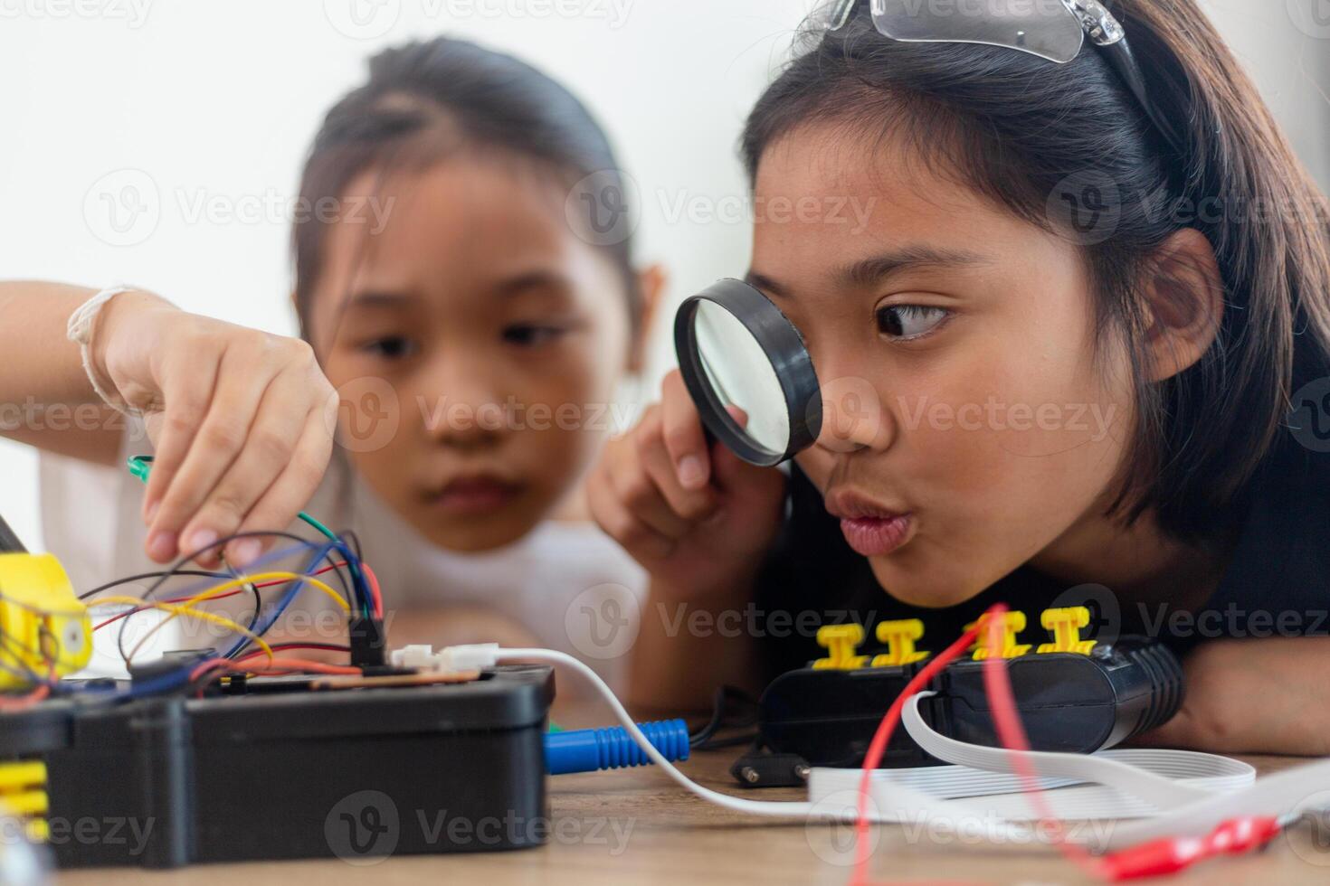 nventive kids learn at home by coding robot cars and electronic board cables in STEM. constructing robot cars at home photo