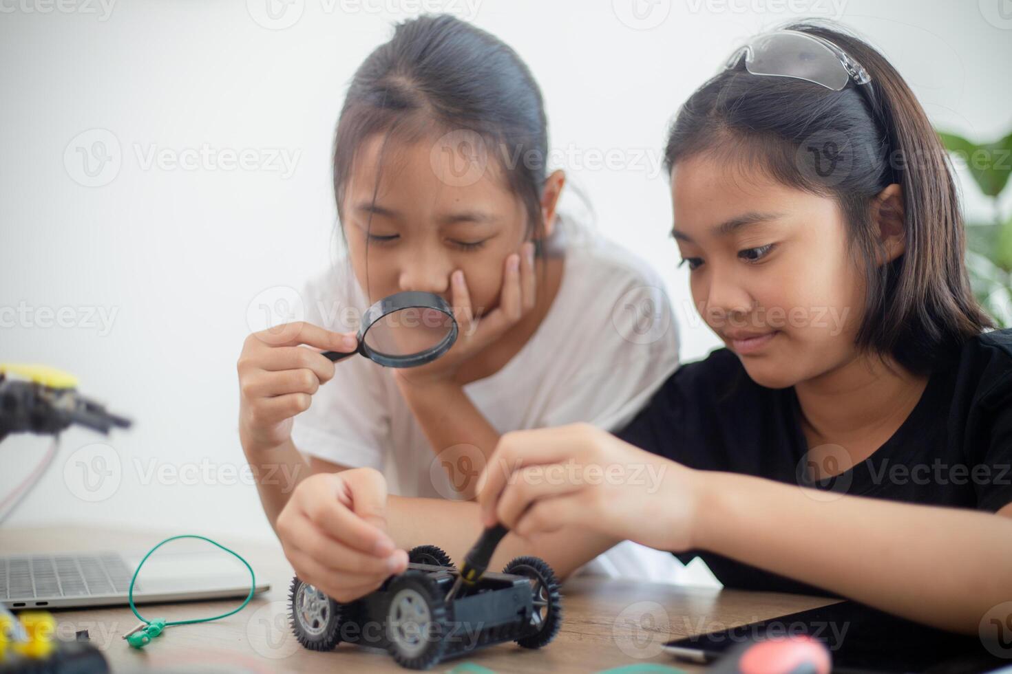 nventive kids learn at home by coding robot cars and electronic board cables in STEM. constructing robot cars at home photo