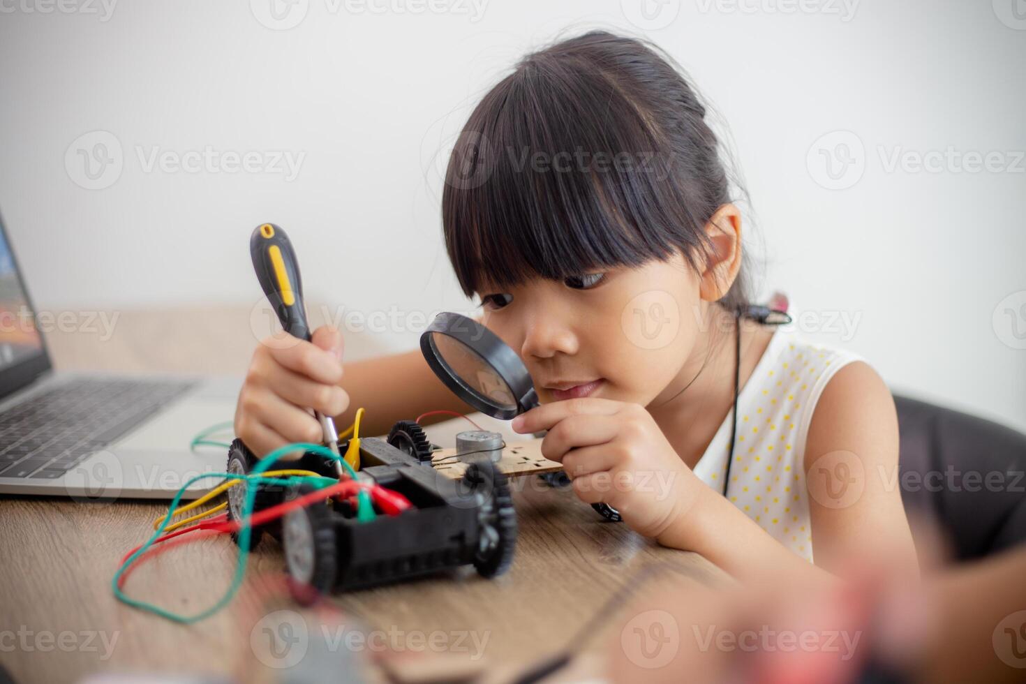 nventive kids learn at home by coding robot cars and electronic board cables in STEM. constructing robot cars at home photo