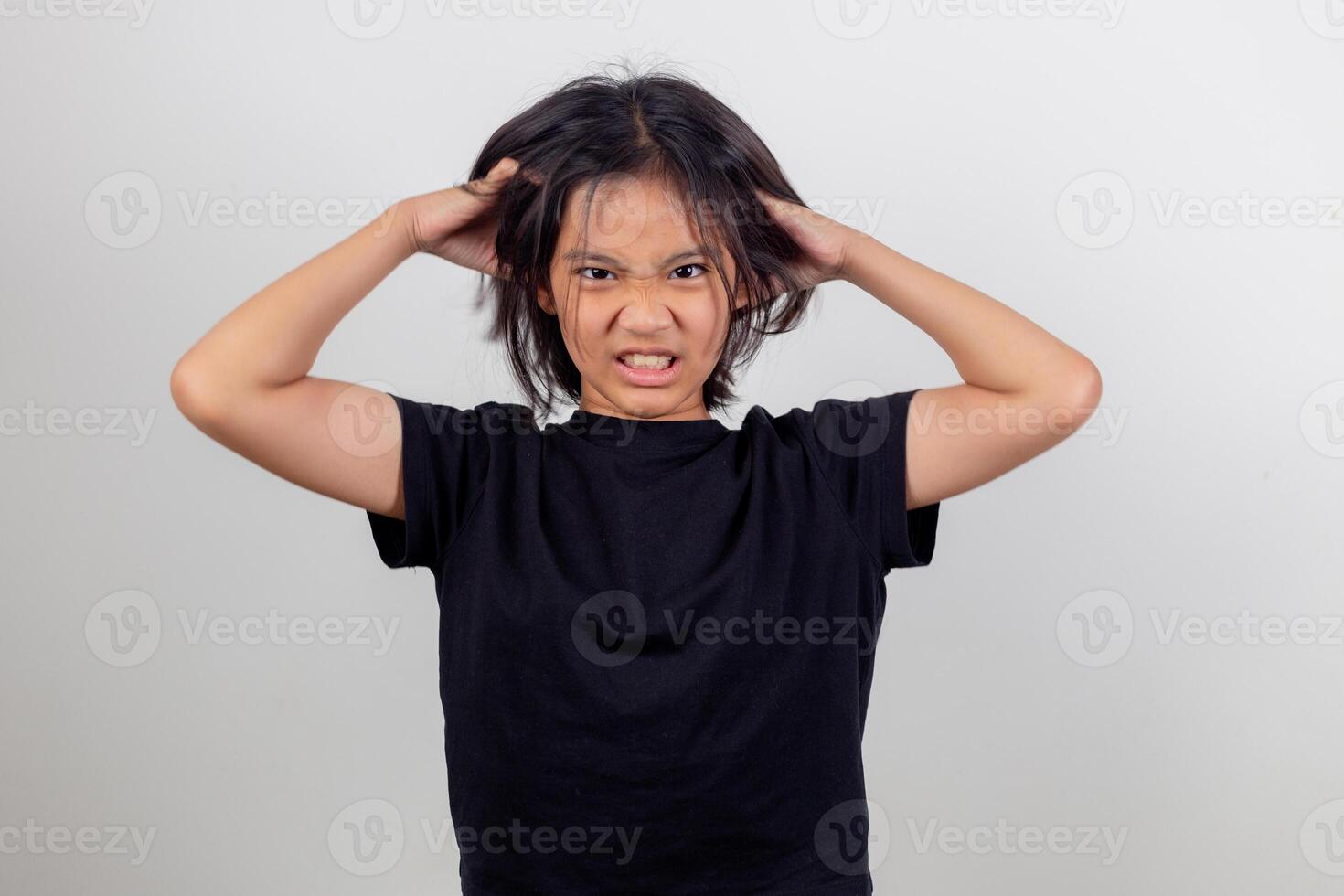 Angry little girl over white background, sign and gesture concept photo