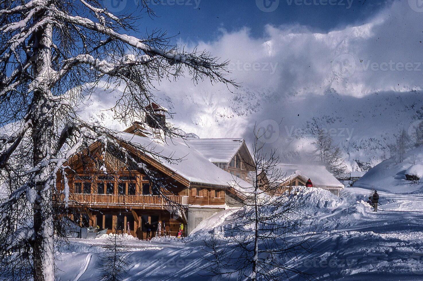 a large building with a ski slope in the background photo