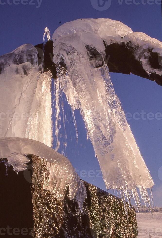 ice covered fountain in the winter photo