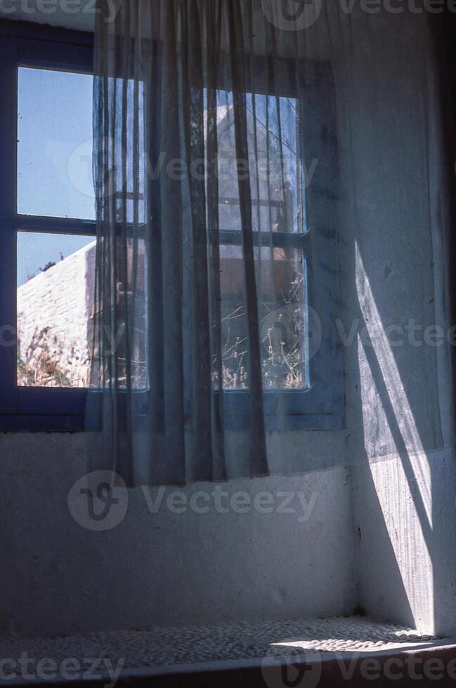 a window with a curtain photo