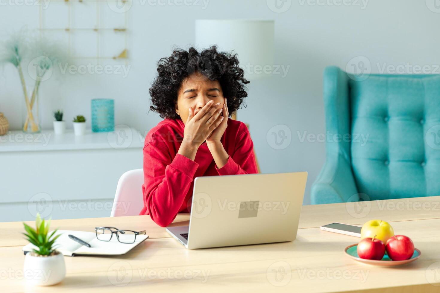 Sleepy african american woman sitting at table with laptop and yawning. Tired overworked girl lazy to work. Student businesswoman relaxing bored in home office after work on laptop computer photo