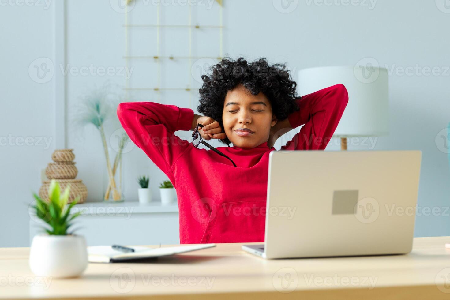 African american girl at home office relaxing stretching hands and body taking break from work on laptop. Joyful young woman freelancer businesswoman happy after work done satisfied by good result photo