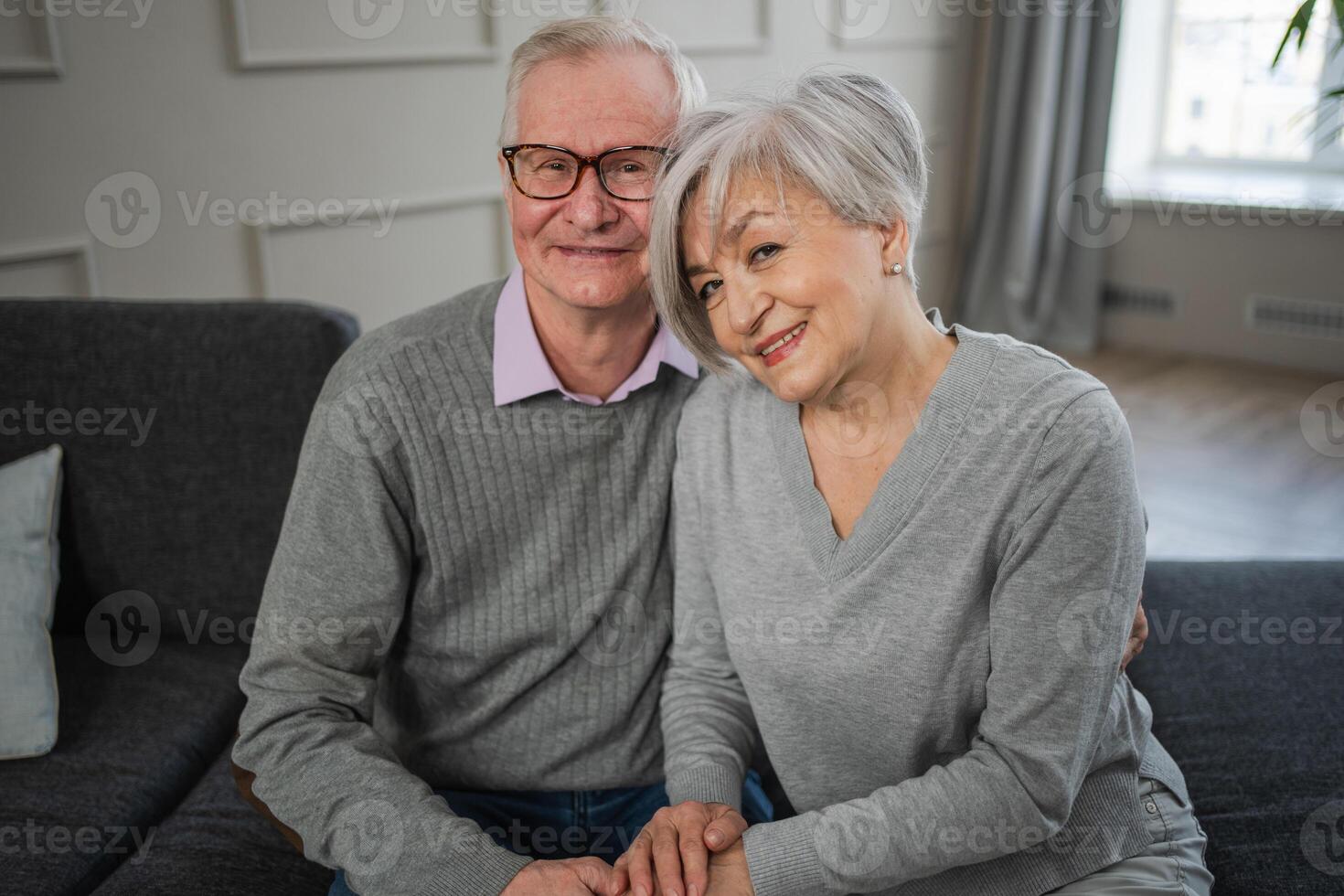 Senior adult mature couple hugging at home. Mid age old husband and wife embracing with tenderness love enjoying sweet bonding wellbeing. Grandmother grandfather together. Family moment love and care photo