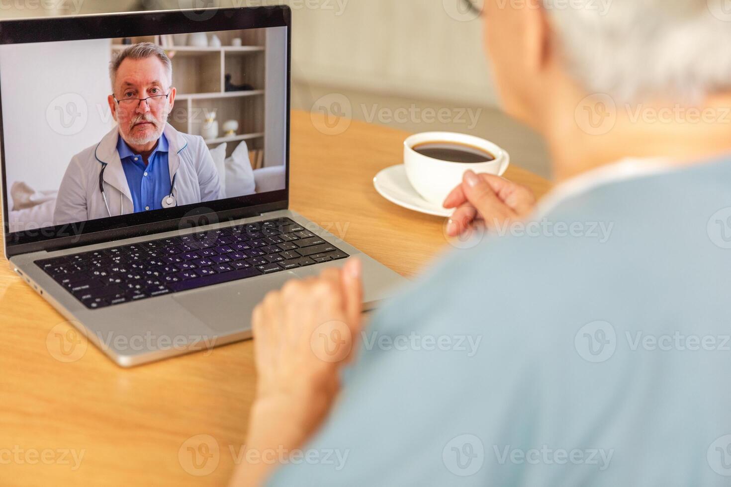 Senior man doctor expert examining older senior woman online. Old woman lady patient and doctor talk on video call have consultation with laptop. Medicine healthcare medical checkup. Online doctor photo