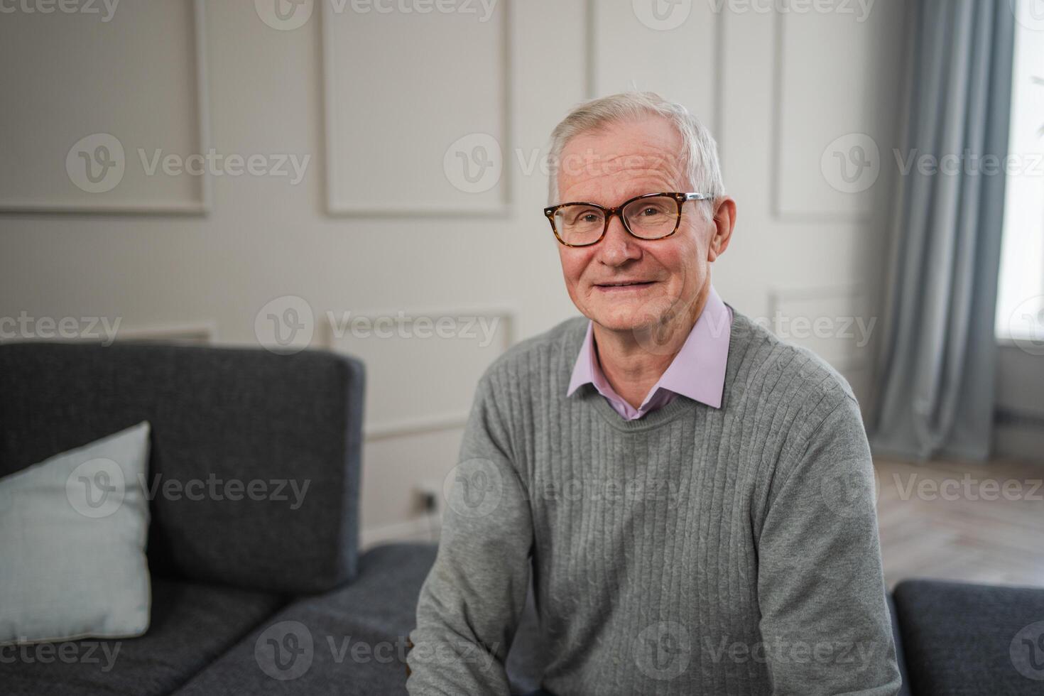 Portrait of confident stylish European middle aged senior man at home. Older mature 70s man smiling. Happy attractive senior grandfather looking camera close up face headshot portrait. Happy people photo