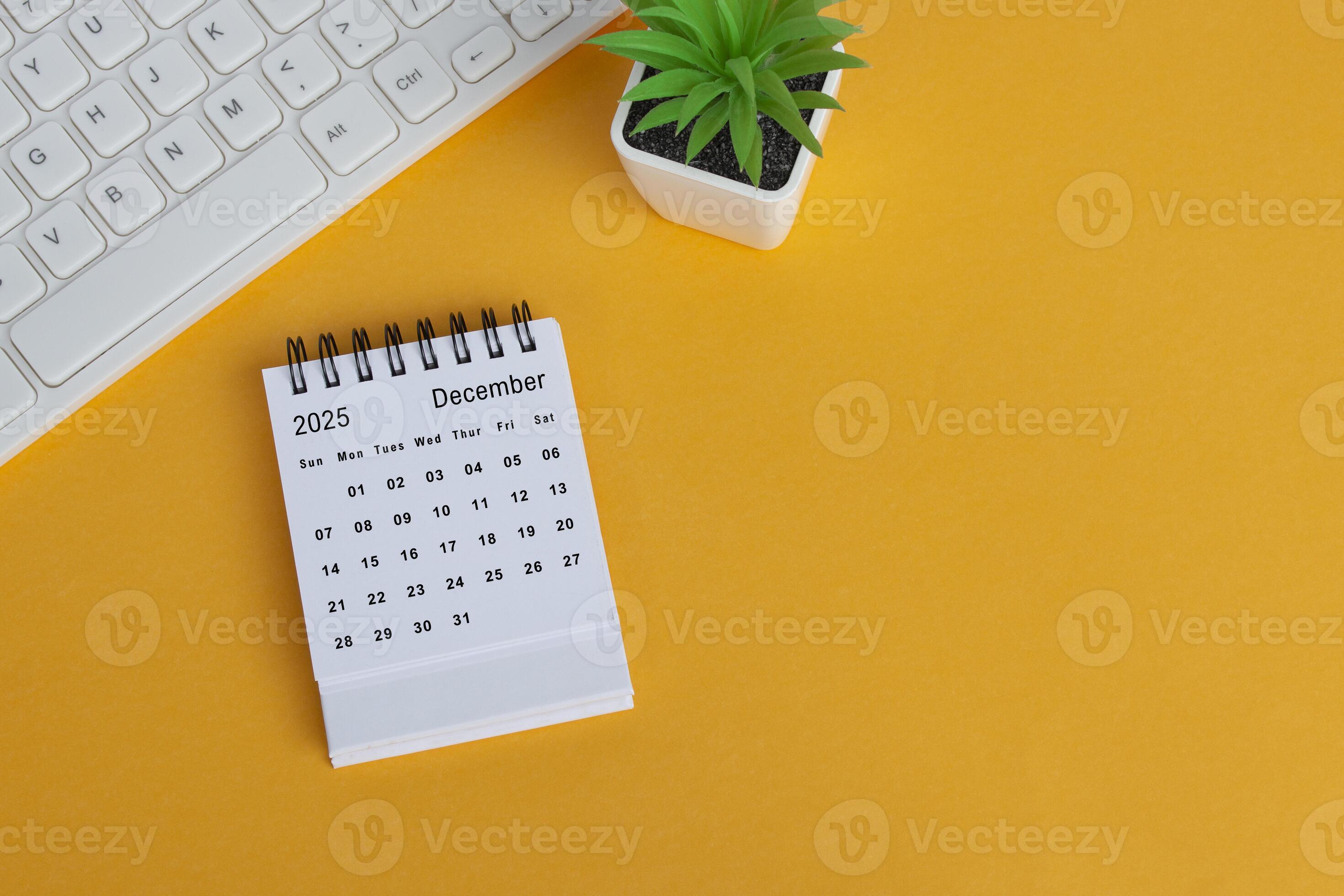 December 2025 desk calendar on yellow background. Directly above. Flat