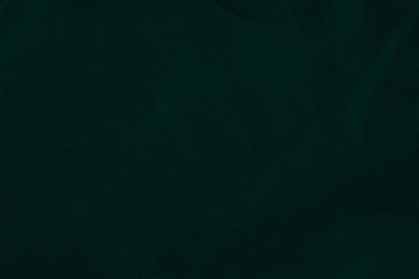 Green velvet fabric texture used as background. Emerald color panne fabric background of soft and smooth textile material. crushed velvet .luxury emerald tone for silk.. photo