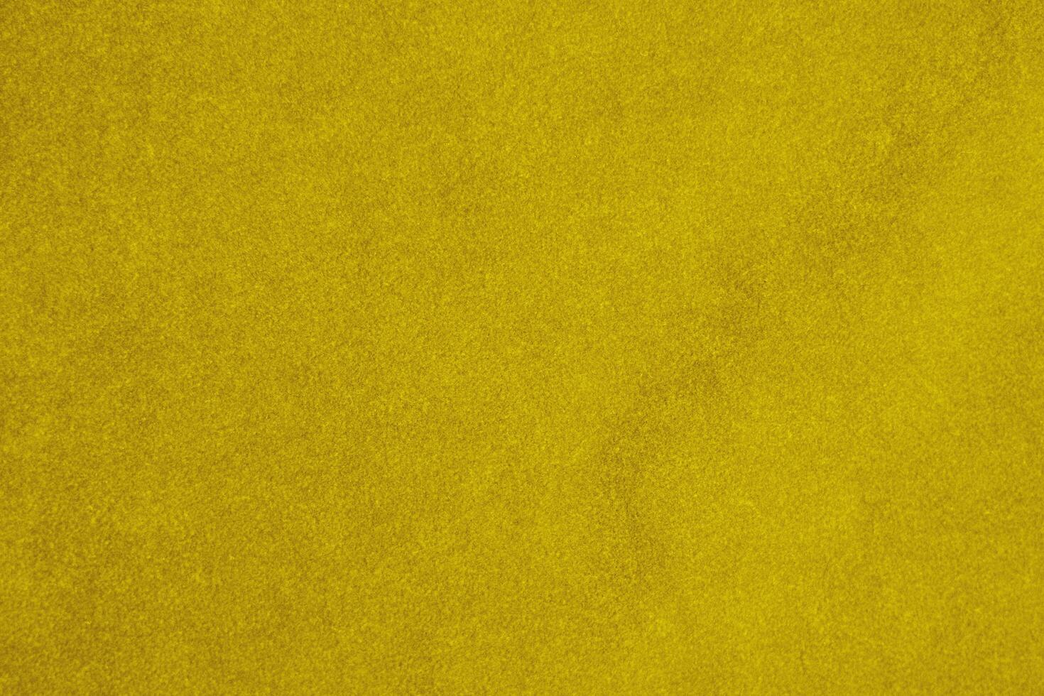 light yellow velvet fabric texture used as background. silk color gold fabric background of soft and smooth textile material. crushed velvet .luxury golden light tone for silk. photo