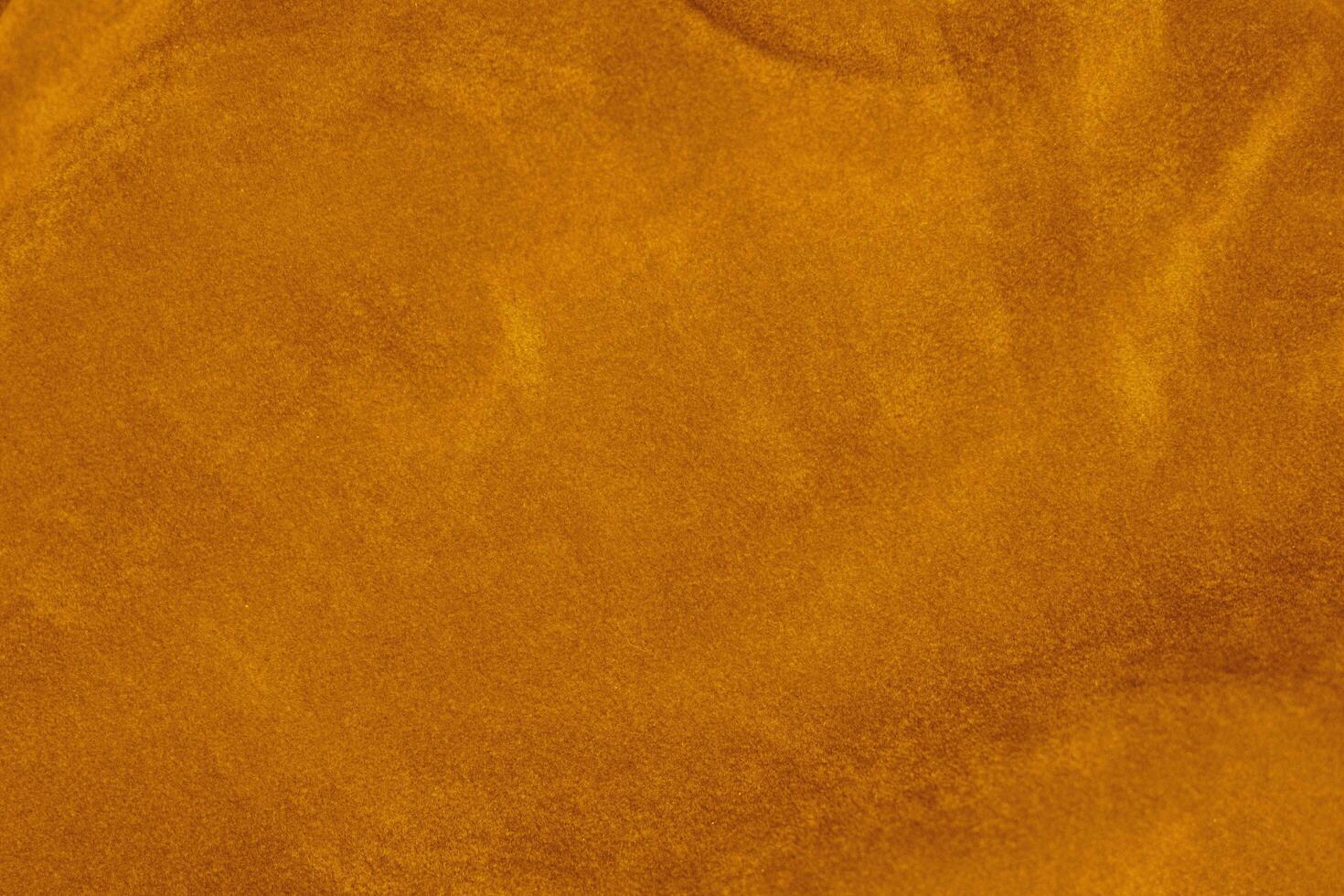 light orange velvet fabric texture used as background. silk color saffron fabric background of soft and smooth textile material. crushed velvet .luxury sun light tone for silk. photo