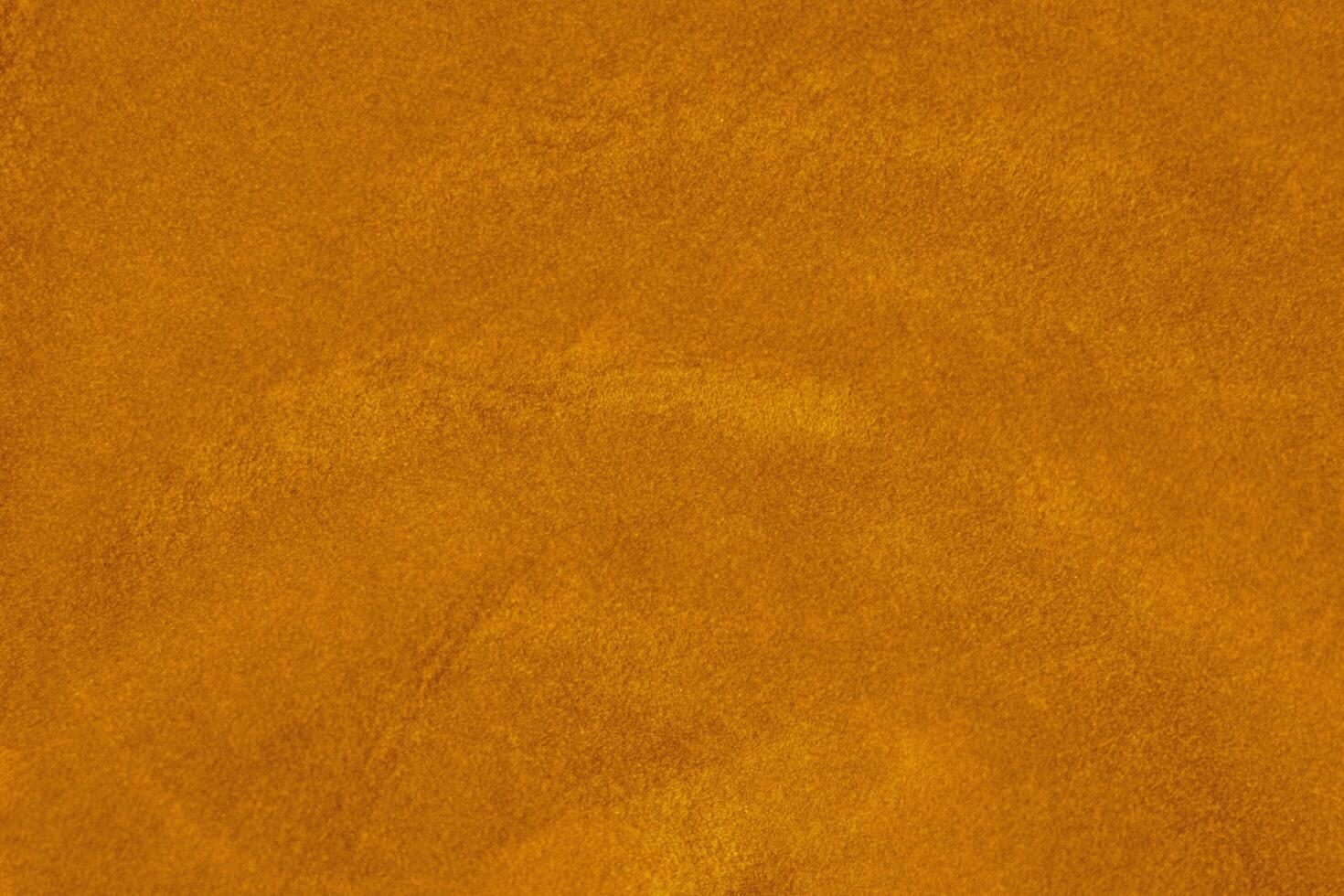 light orange velvet fabric texture used as background. silk color saffron fabric background of soft and smooth textile material. crushed velvet .luxury sun light tone for silk. photo